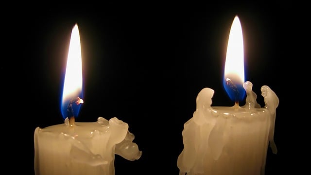 Two softly glowing candles symbolize remembrance and emotional comfort, reflecting the compassionate care offered through Orange City, FL cremation services.