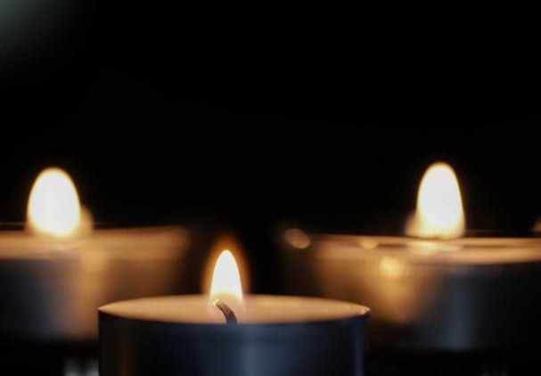 Lit tea light candles create peaceful cremation remembrance setting in Deltona, FL.