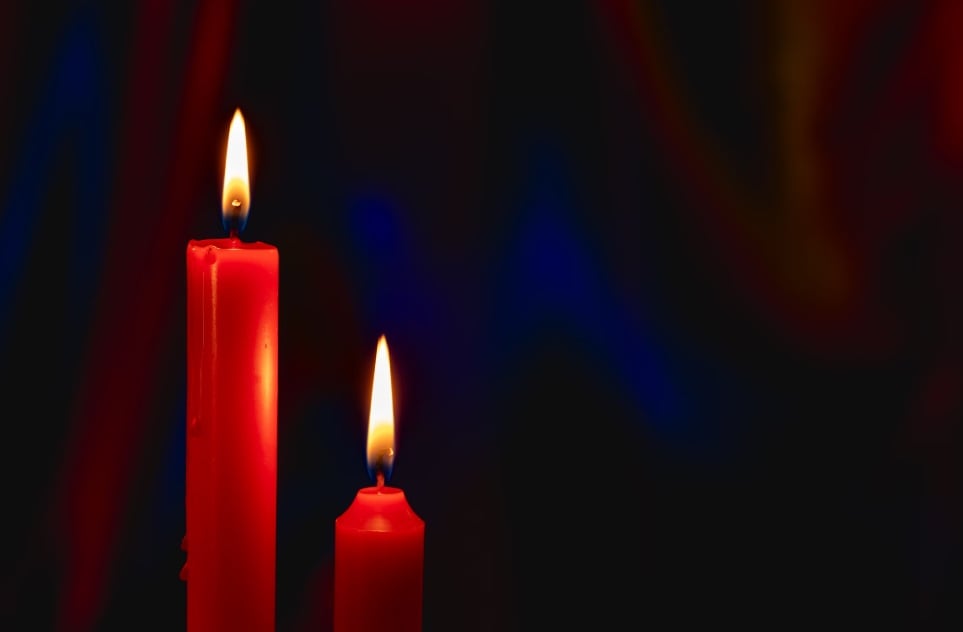 Two red candles glowing during a quiet remembrance in Orange City, FL.